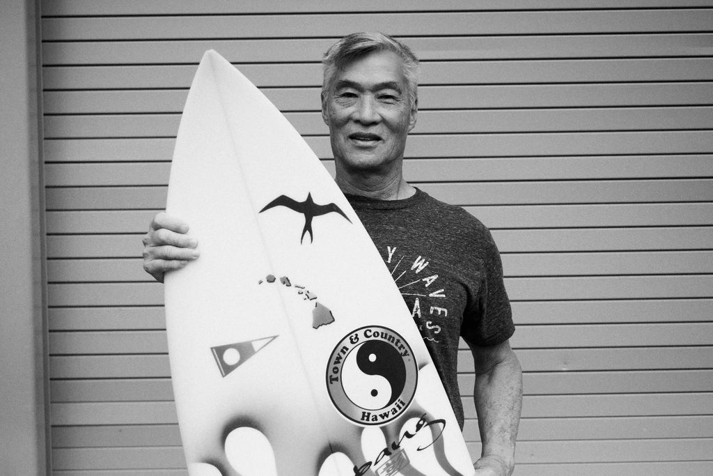 Picture of Glenn Pang - shaper from Hawaii - posing with one of his boards for Lucid Glassing