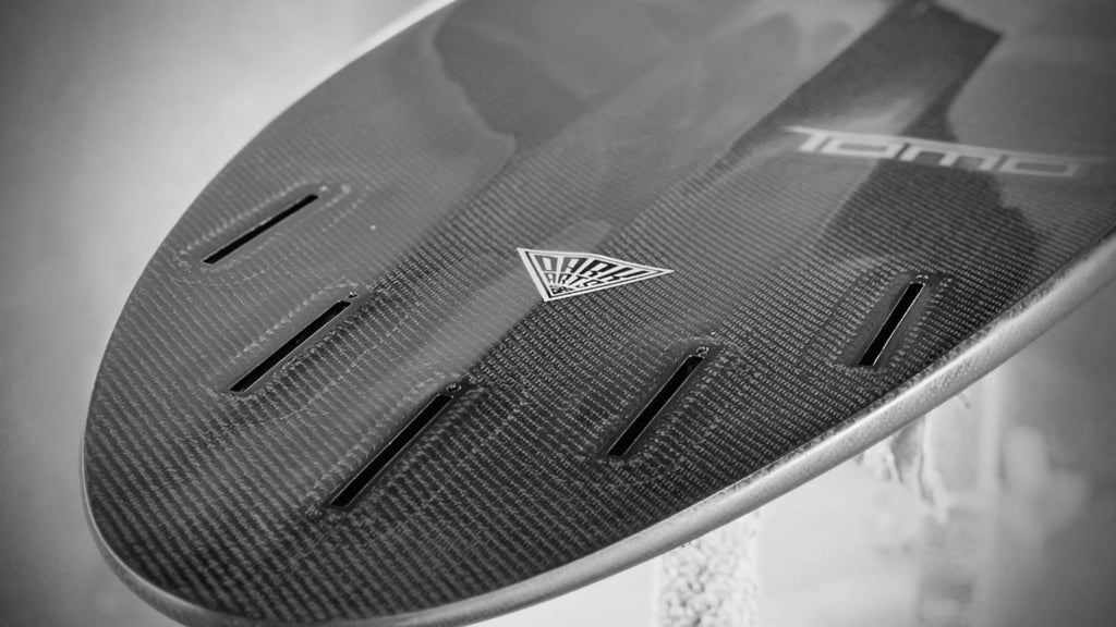 Close up of Dark Arts Surf logo on the bottom of Tomo carbon surfboard tail built at Lucid Glassing Australia